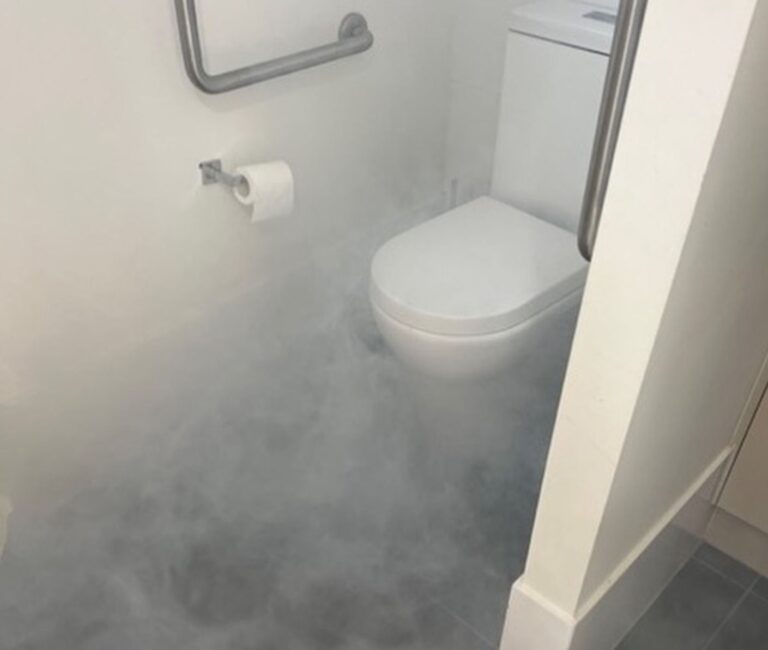 Smoke Test showing drain pipe break behind toilet